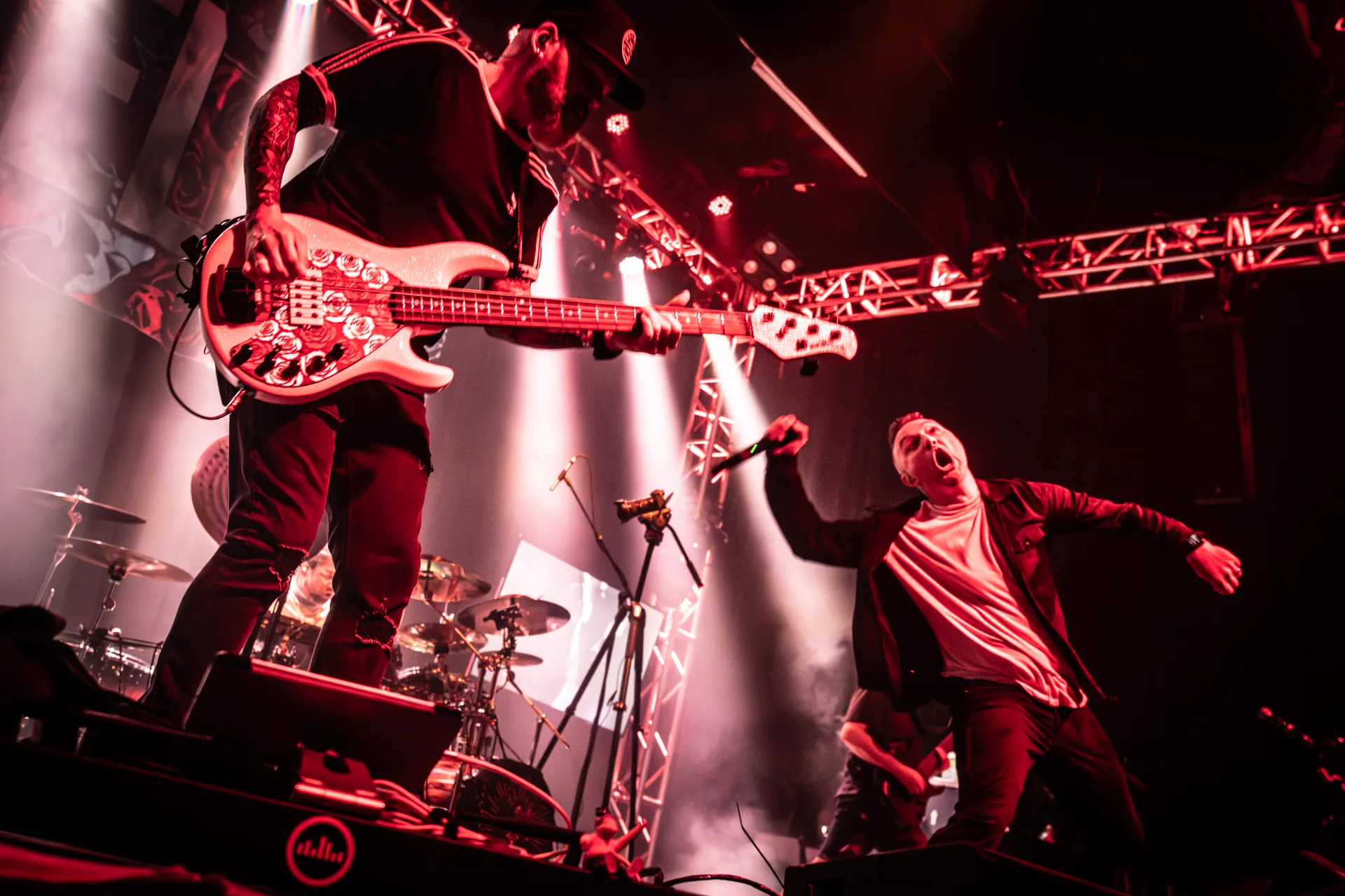 Elite’s guitarist and vocalist under red stage lights